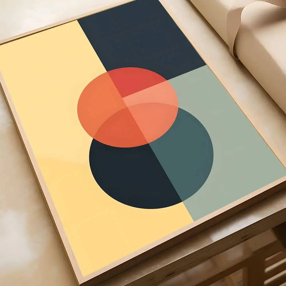 Mid-century abstract canvas print showing overlapping orange and navy circles against a split yellow, navy, and sage background, in a wood frame.