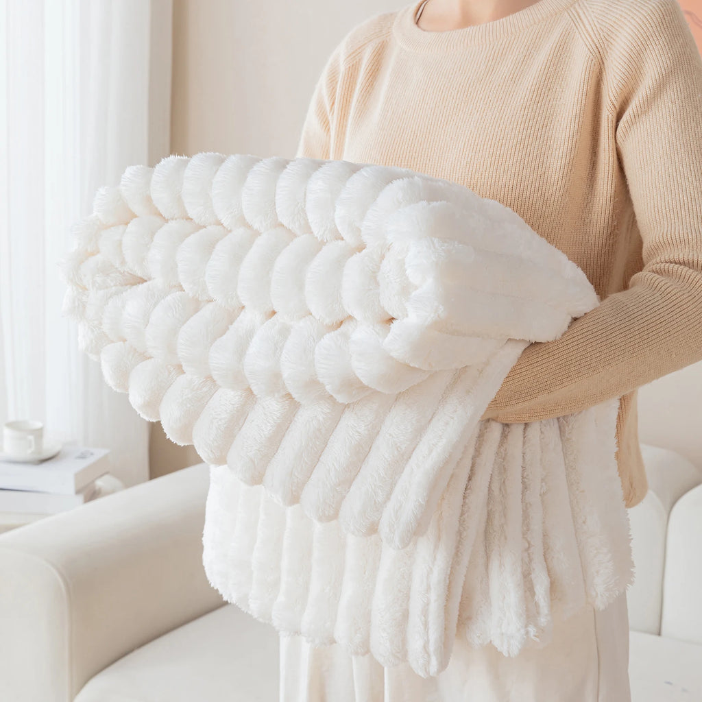 Person holding a large white textured pillow in a cozy indoor setting