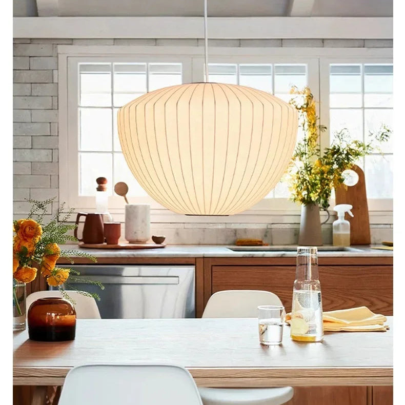 Warm glowing silk pendant lamp in a modern lounge with glass block walls