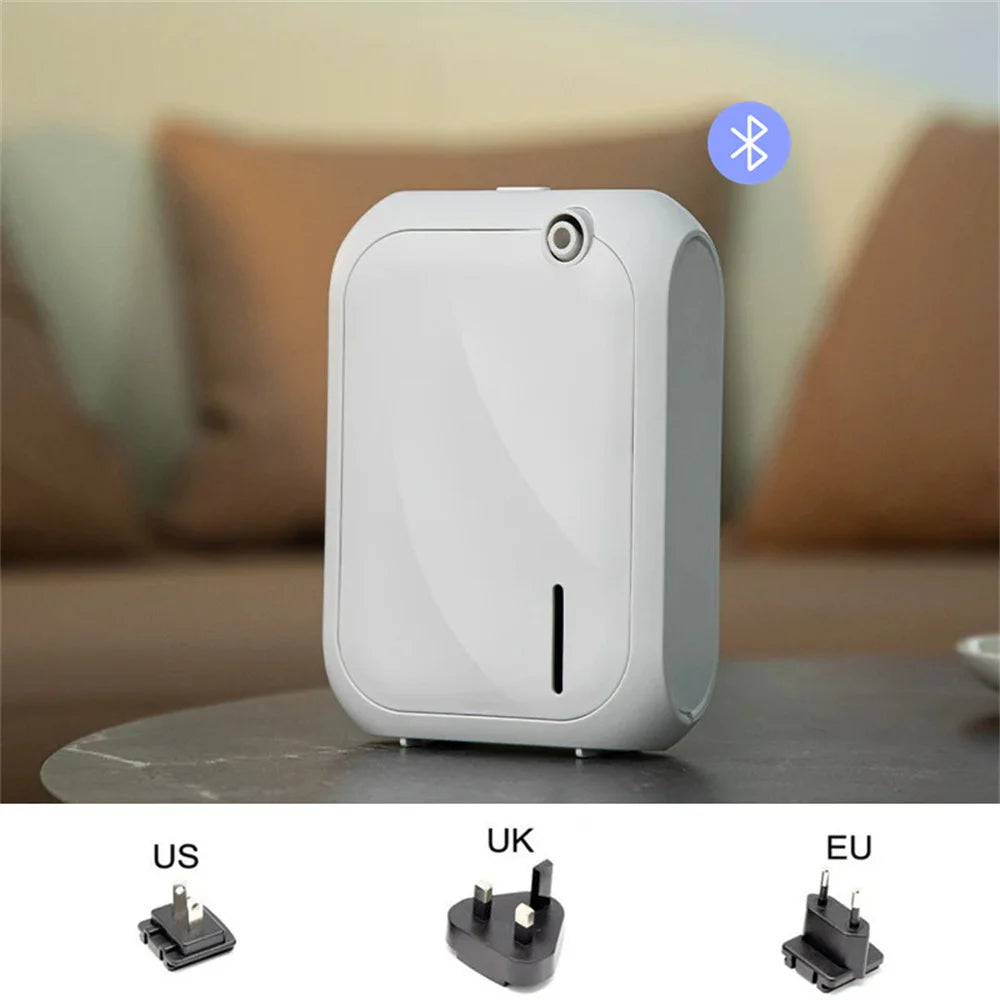 White Bluetooth essential oil diffuser on a tabletop with a minimalist design
