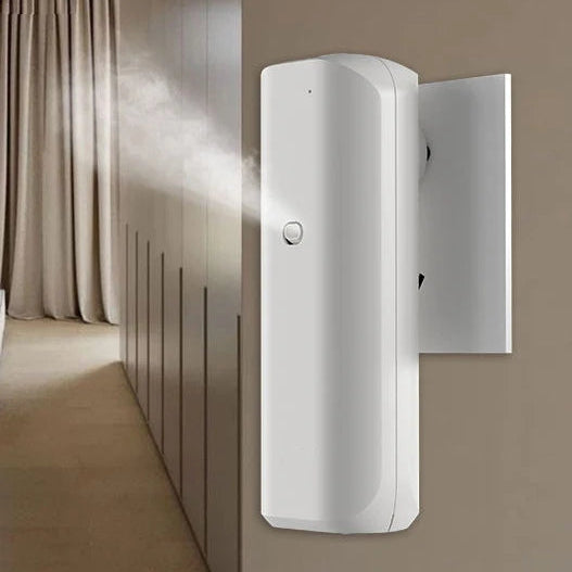 Wall-mounted white plug-in electric diffuser installed on tiled wall