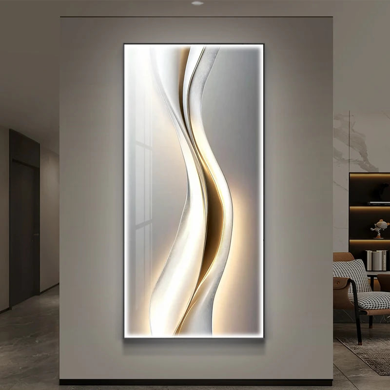 White and gold fluid wave LED wall art panel illuminated on a grey wall in a modern hallway