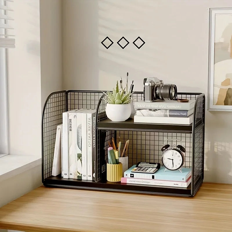 Black metal desk organizer with books, plants, and stationery on a wooden surface.