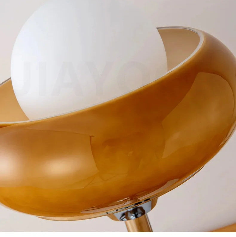 Glass lampshade with brown outer cover and white inner cover on a plain background