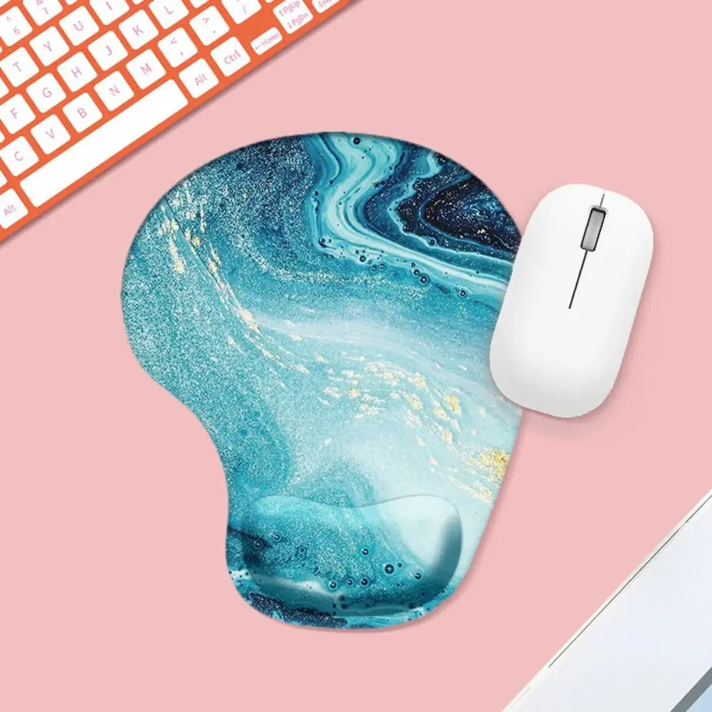 Mouse pad with blue and white abstract design on a pink surface with a keyboard and mouse.