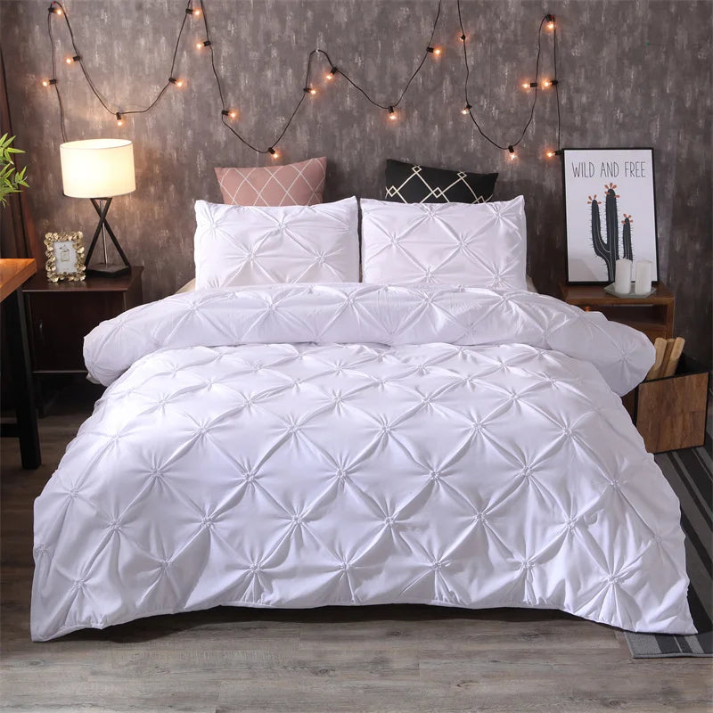 White pintuck duvet set with matching pillowcases dressed on a double bed in a warm contemporary bedroom