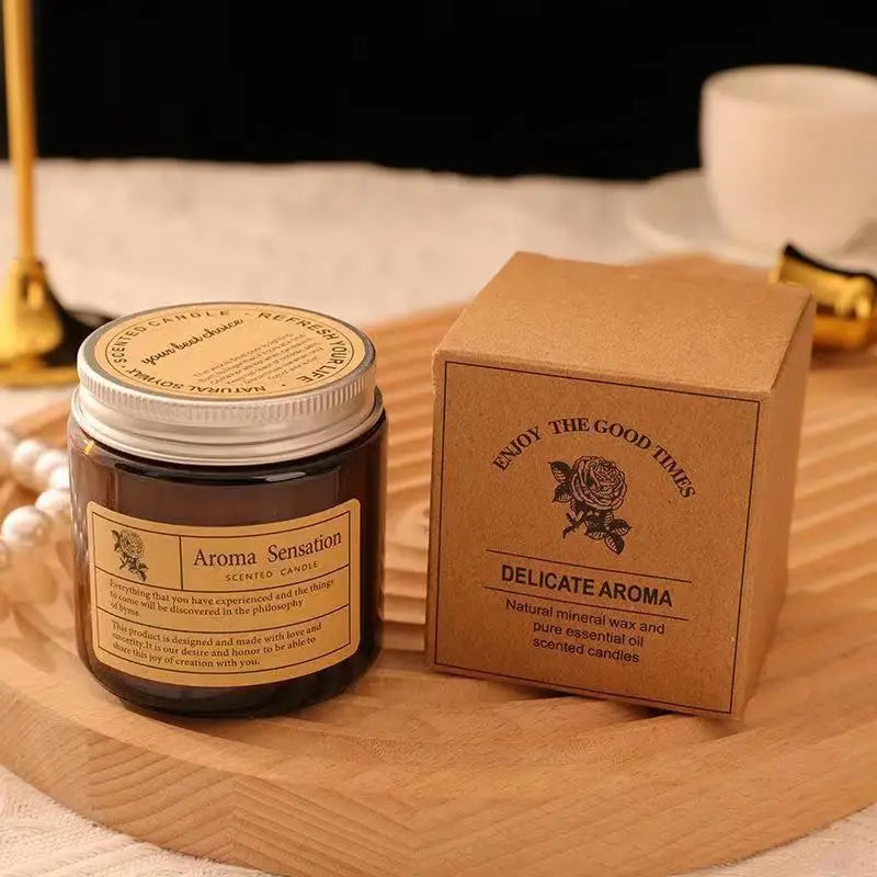 Aroma Sensation scented candle jar with a brown box on a wooden surface