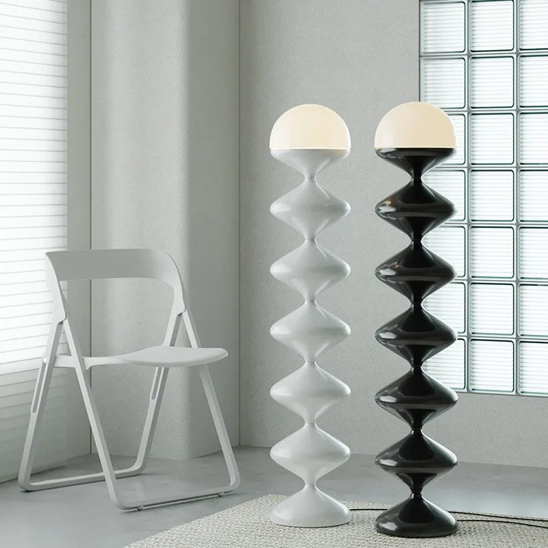 Black and white sculptural floor lamps with frosted dome shade