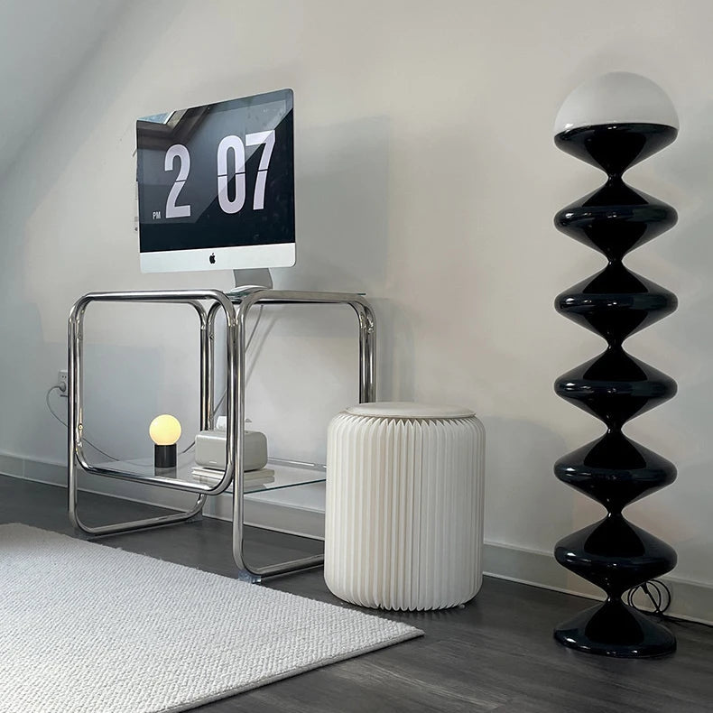 Black sculptural floor lamp with frosted dome shade