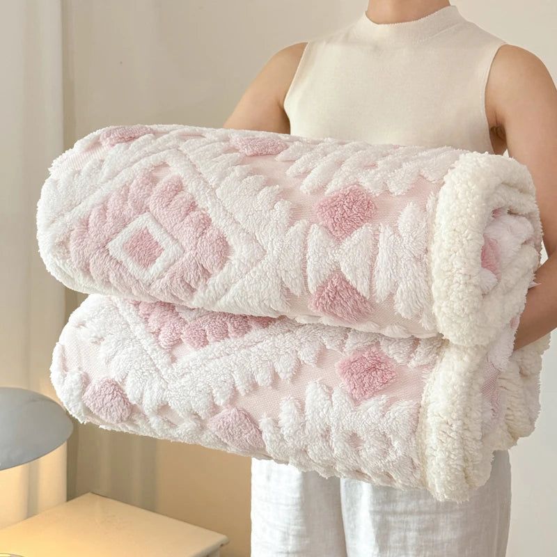 Person holding a stack of pink and white textured blankets.