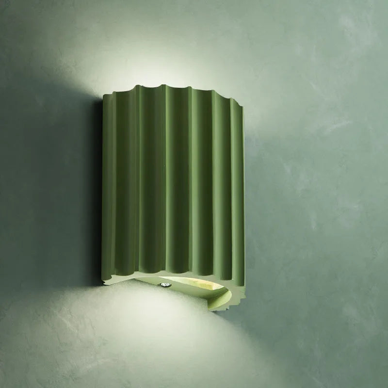 Sage green ribbed resin wall lamp with minimalist fluted design.