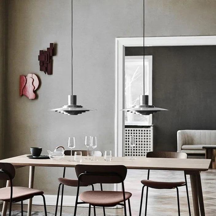 Silver aluminium pendant light styled above a modern interior setting