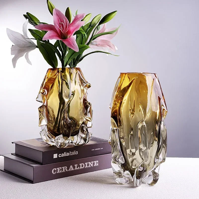 Side-by-side comparison of small and large modern amber glass vases with lilies.