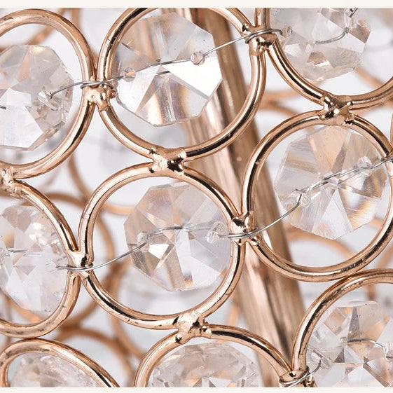 Close-up of a decorative wall sconce with crystal elements and gold metalwork.