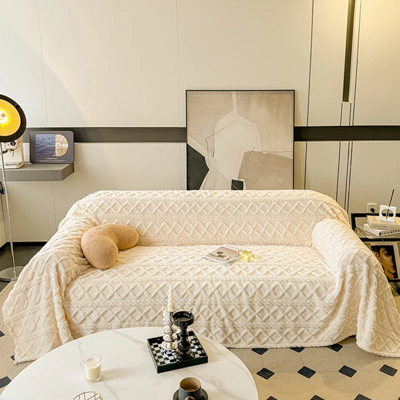 Beige textured throw blanket draped over a sofa in a stylish living room.