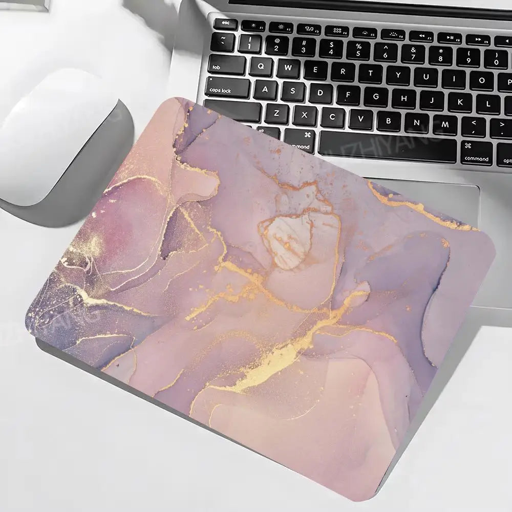 Marble-patterned mouse pad on a laptop with keyboard and mouse.