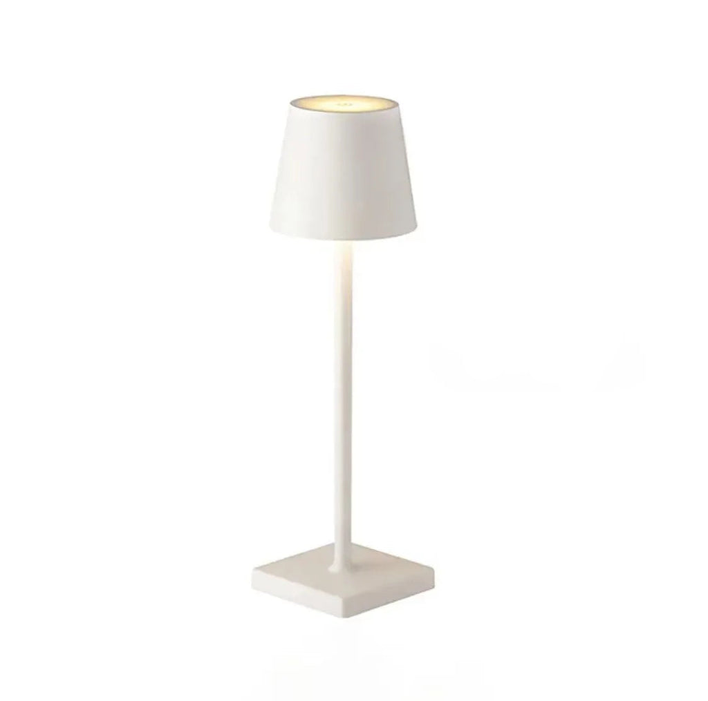 A white table lamp with a square base on a white background