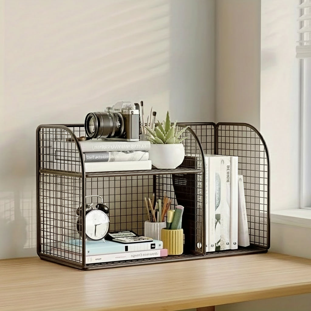 Black metal grid shelf with books, plants, and stationery on a wooden surface.
