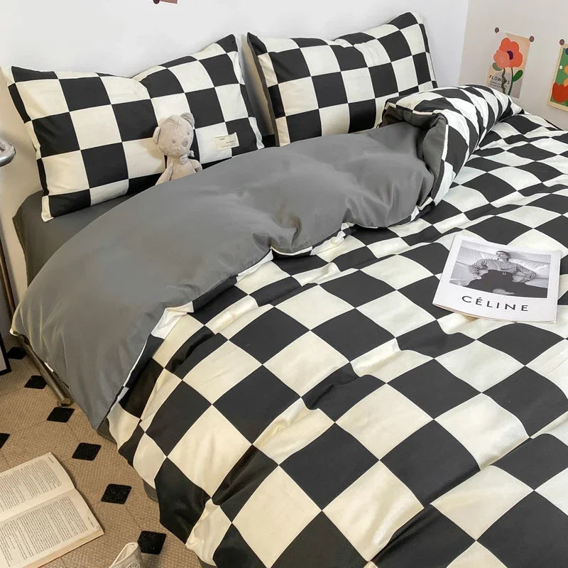 Black and white checkerboard duvet cover set with matching pillowcases dressed on a double bed in a modern styled bedroom