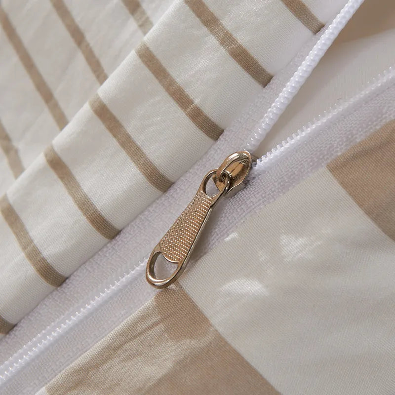 Close-up of a zipper on a fabric with beige and white stripes.