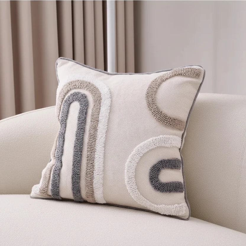 Decorative pillow with geometric pattern on a beige sofa