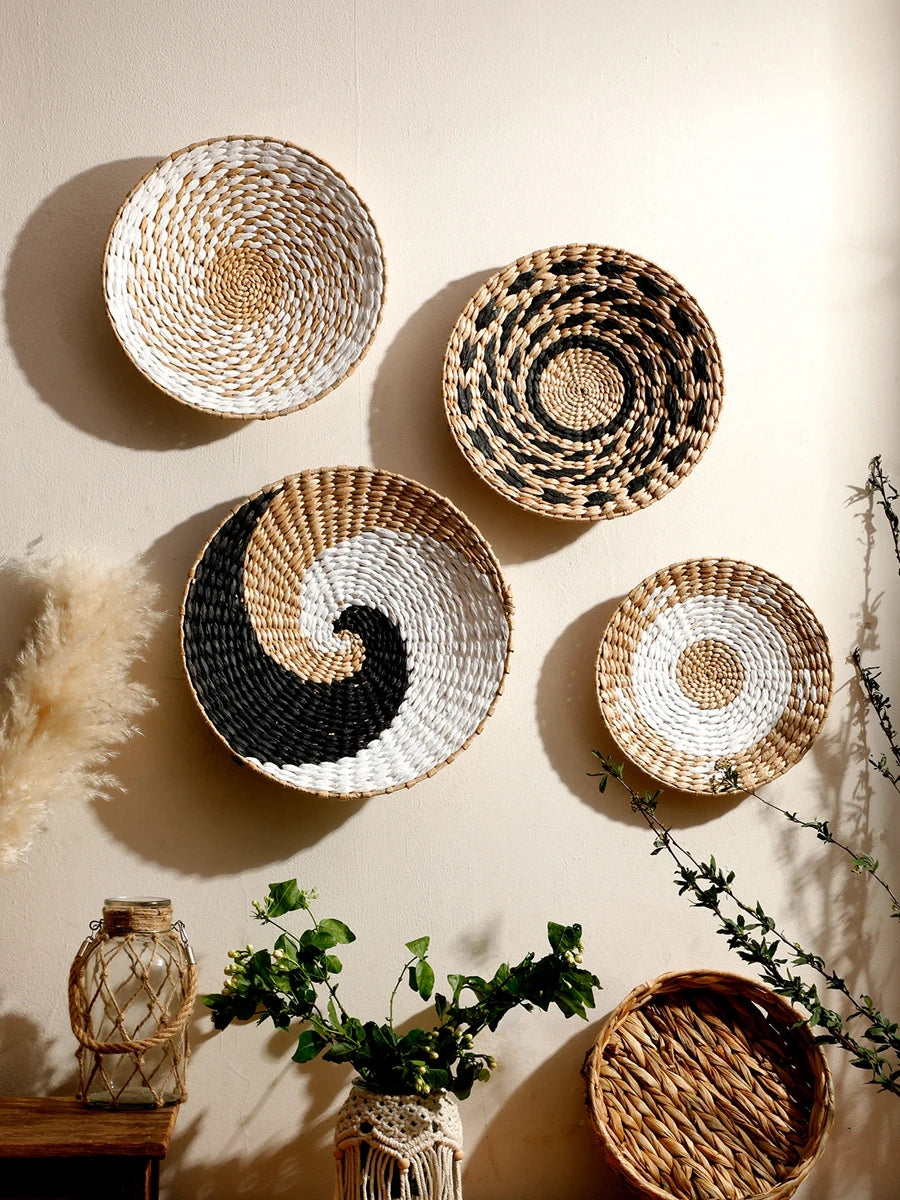 Woven baskets of various sizes and patterns on a wall with a soft focus background