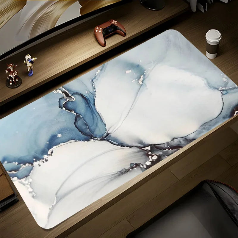 Desk setup with a large decorative mat featuring abstract designs on a wooden desk.