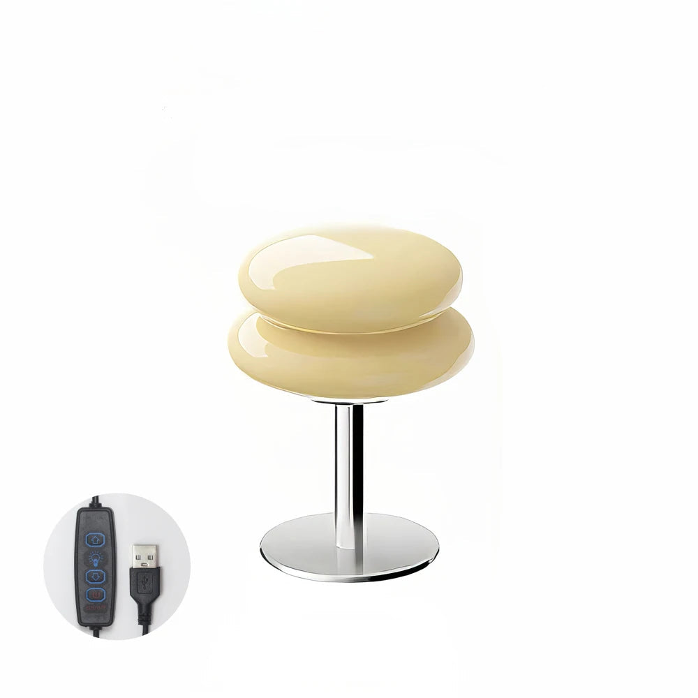 A cream coloured table lamp and a USB cable icon on a white background