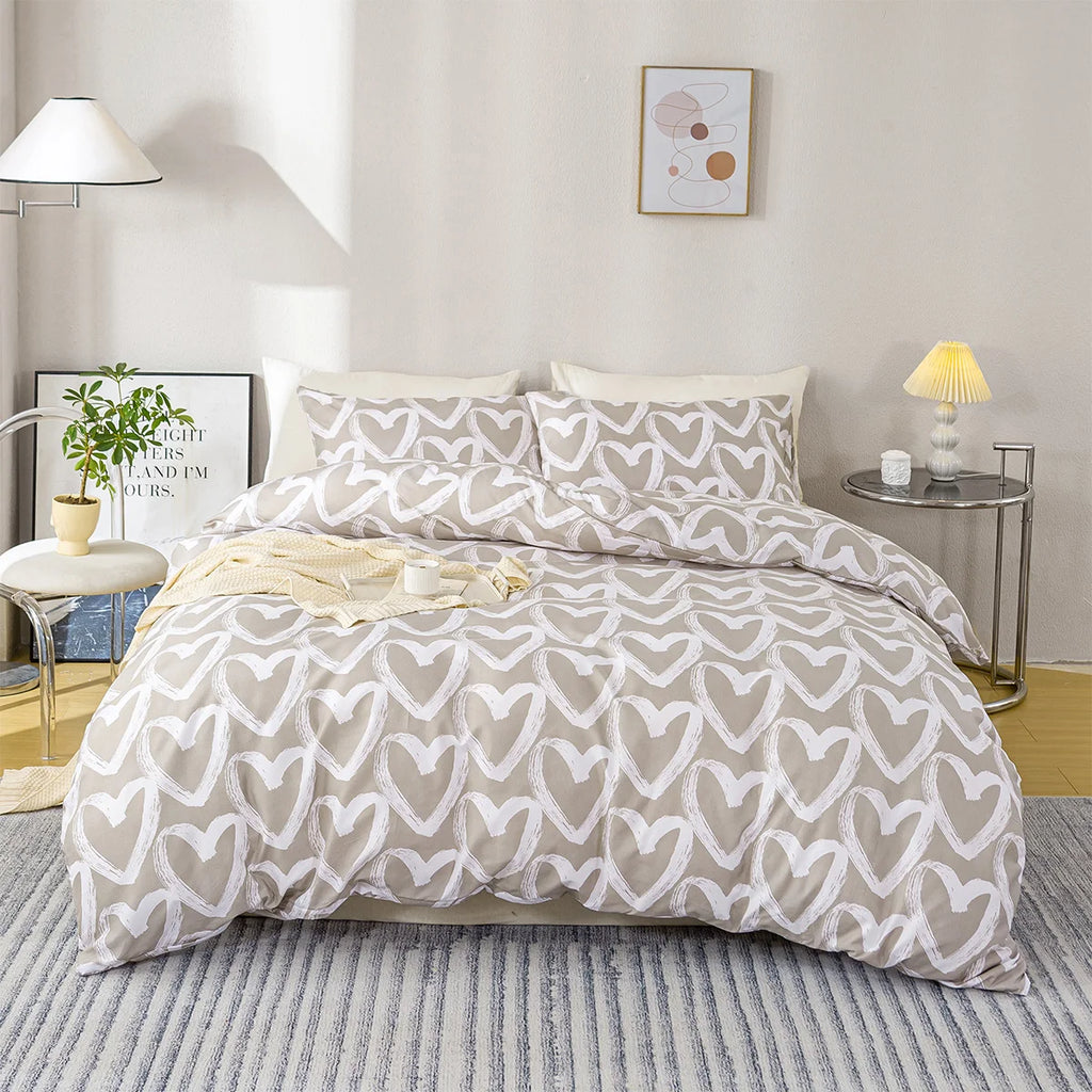 Beige and white heart-patterned comforter set on a bed in a bedroom setting.