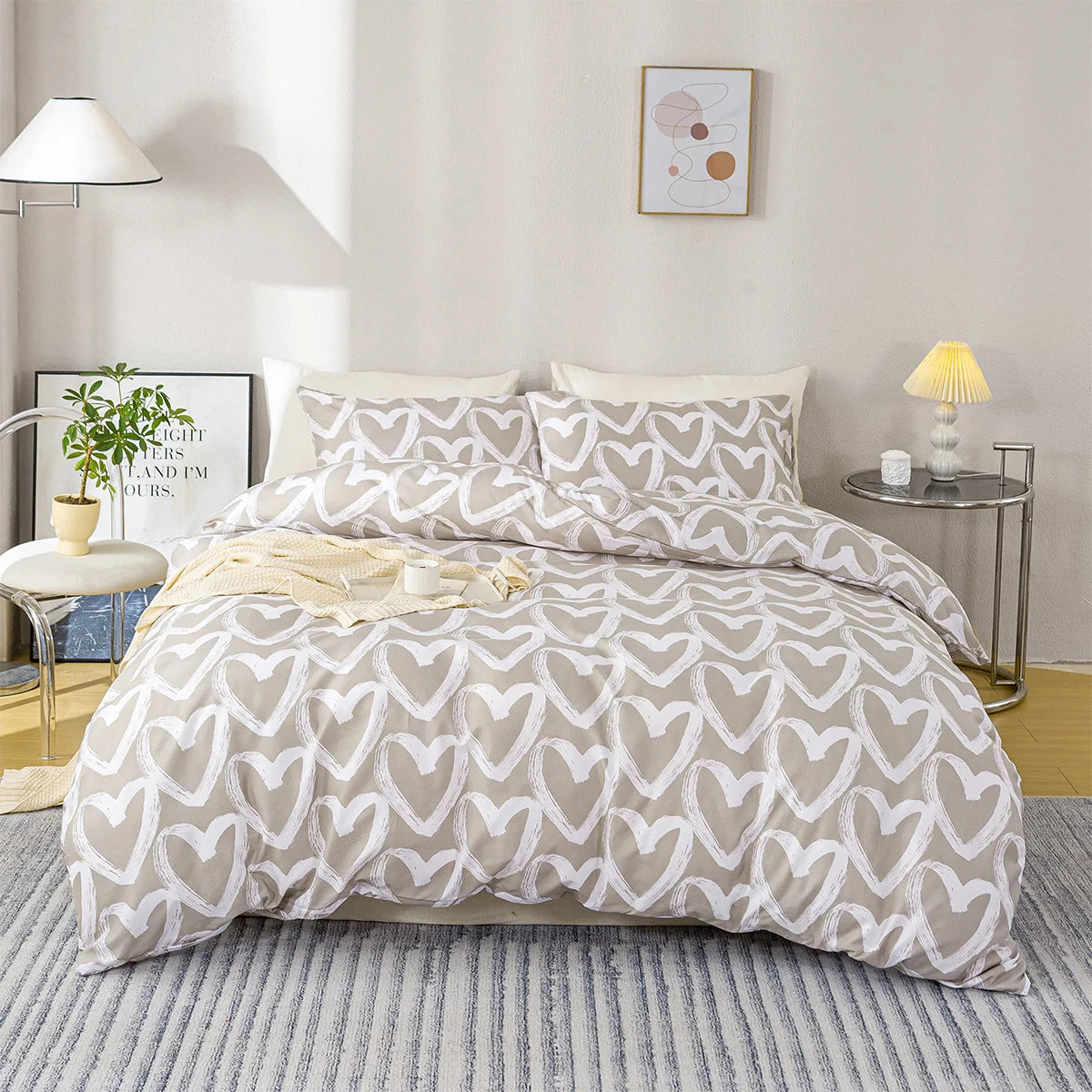Beige and white heart-patterned comforter set on a bed in a bedroom setting.
