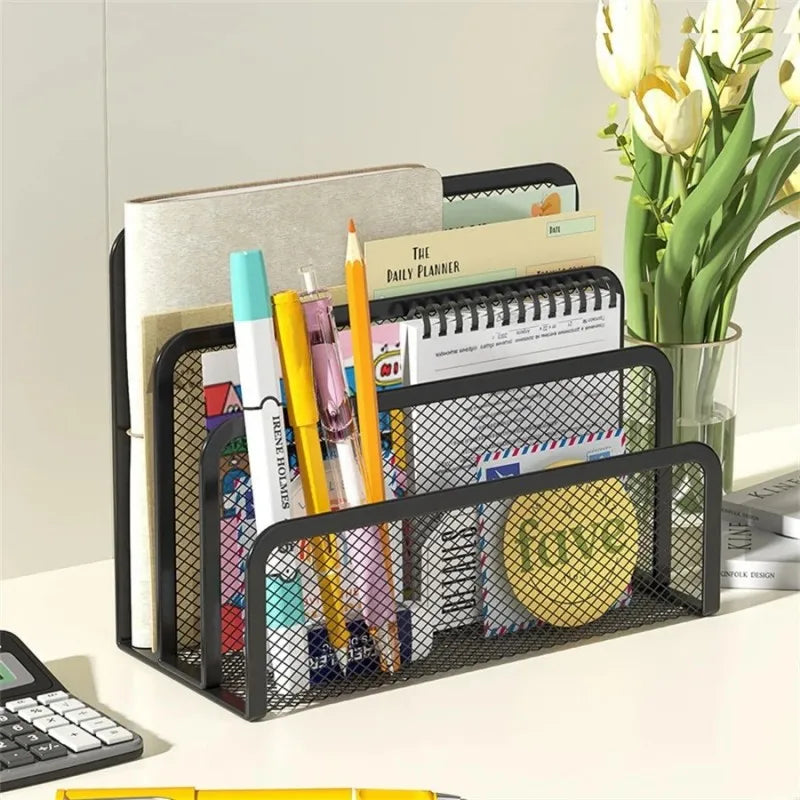 Black mesh desk organizer with stationery items on a desk.