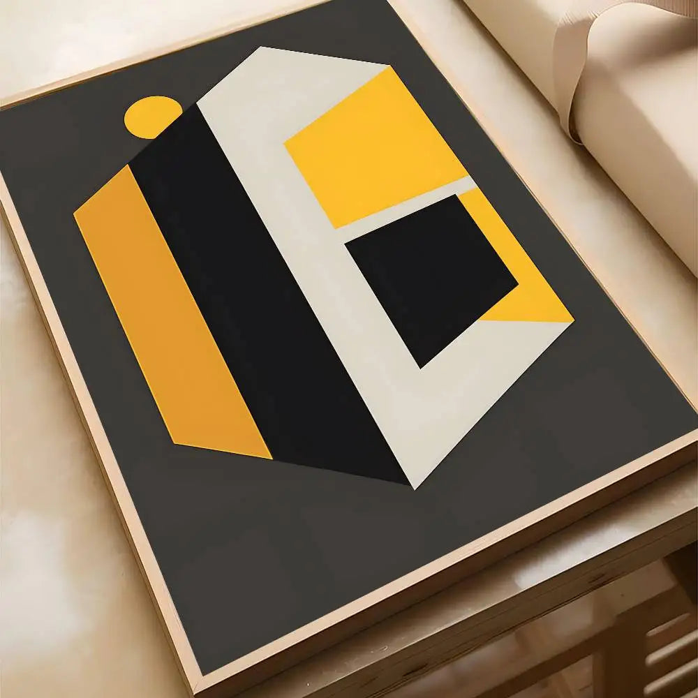 Geometric abstract canvas print featuring angular shapes in gold, grey, and black on a dark charcoal background, set in a natural wood frame.