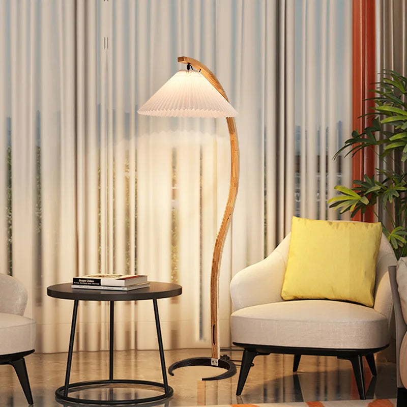 Modern living room with a floor lamp, side table, and armchair with a yellow pillow.