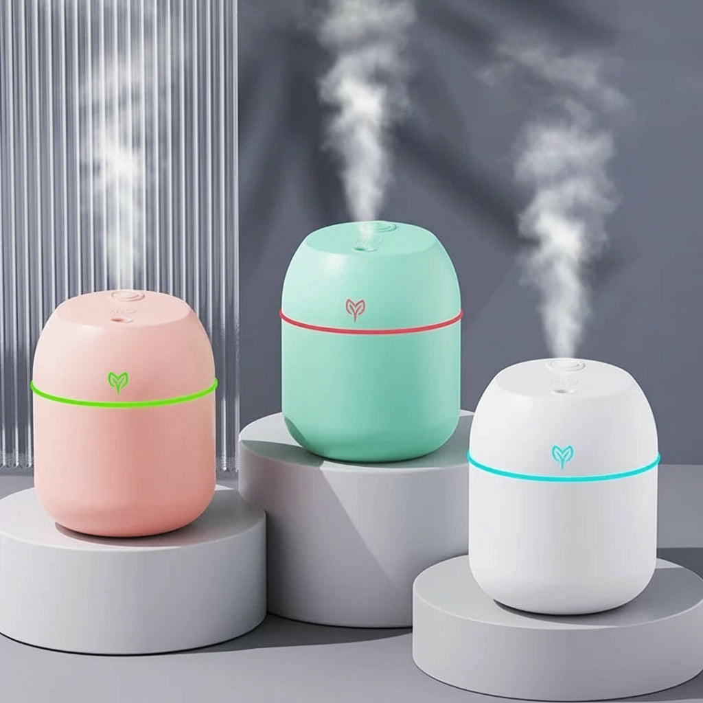 Three colorful humidifiers emitting steam on a neutral background