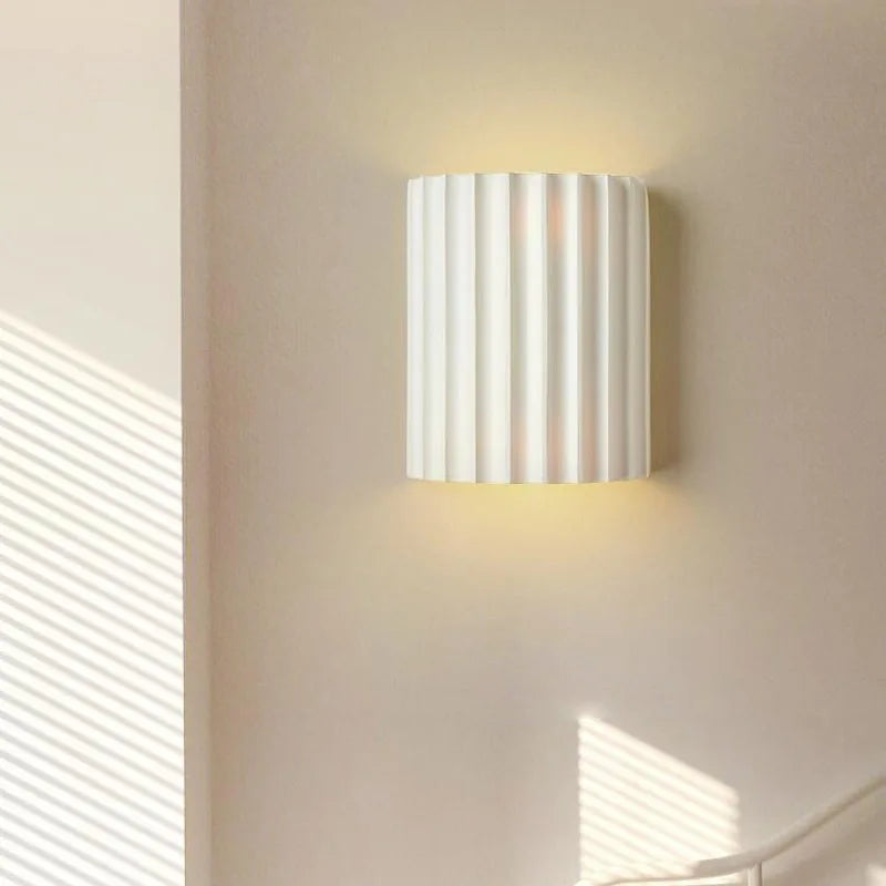White ribbed resin wall lamp with smooth fluted texture.