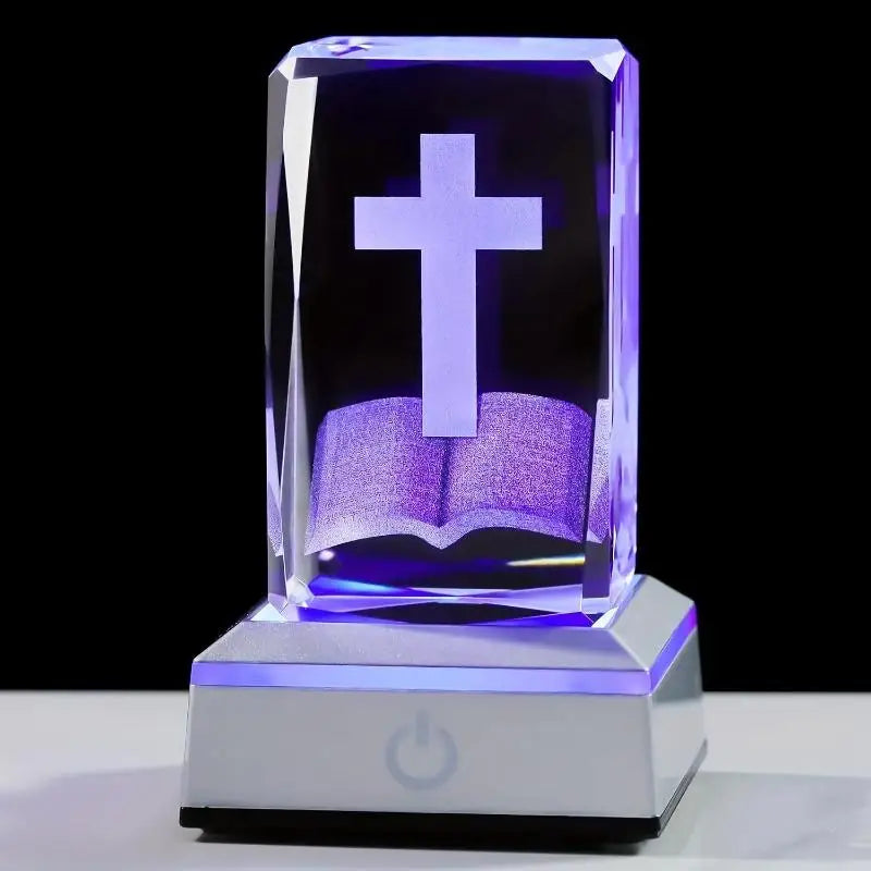 Crystal block with a cross and book design on a black background