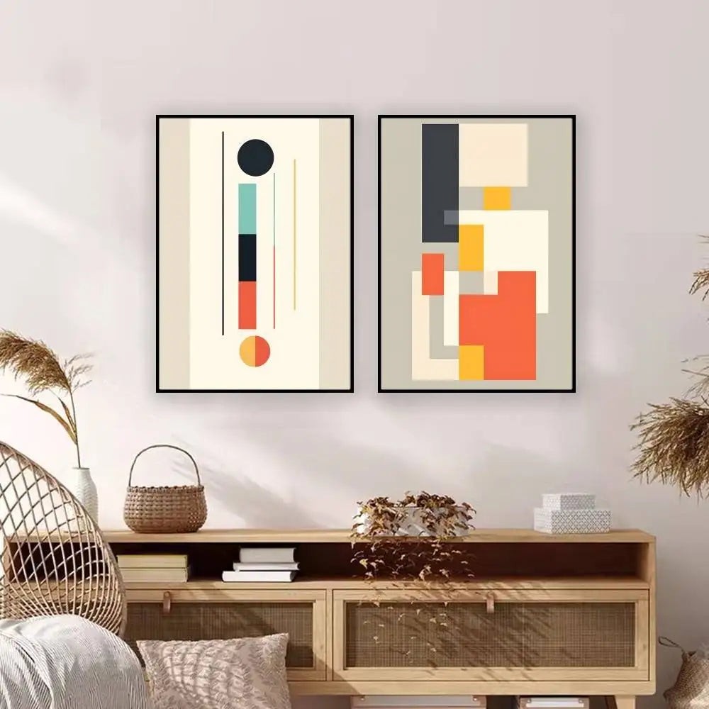 Two abstract art pieces on a wall above a wooden console table.