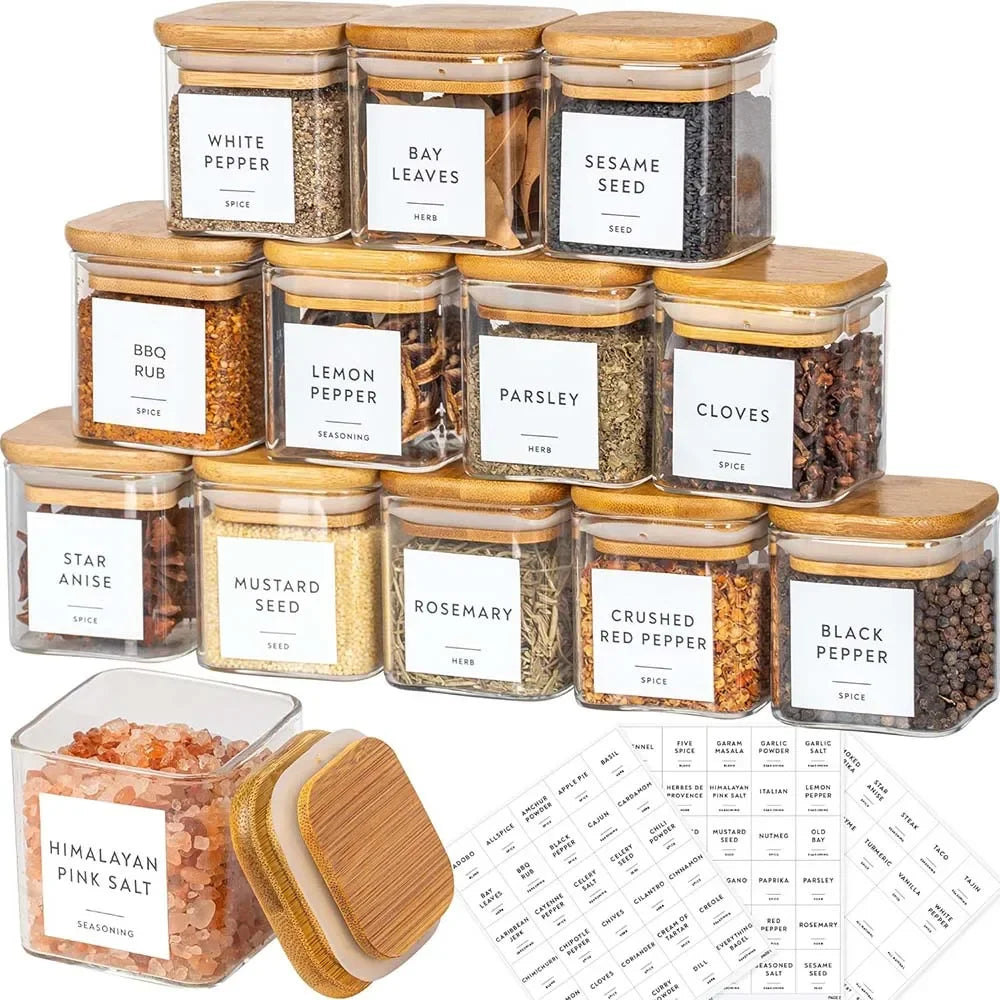 Set of glass spice jars with wooden lids and labeled labels on a white background.