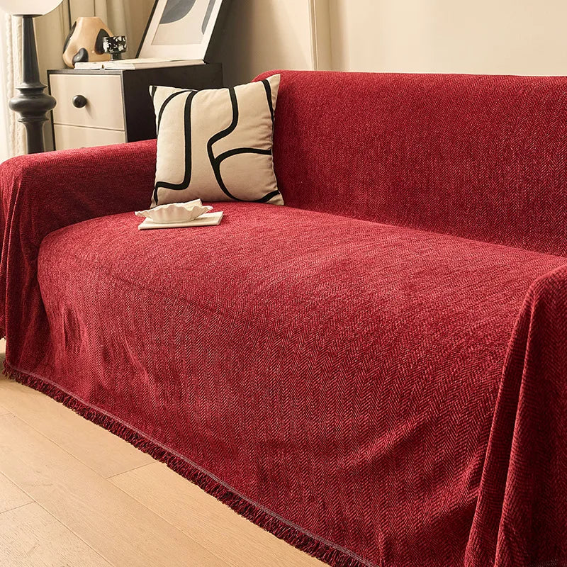 Ruby Red deep-toned chenille sofa cover draped over a large couch in a contemporary living room.