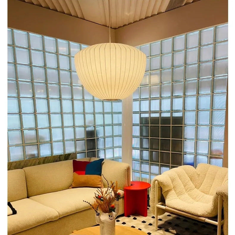 Warm glowing silk pendant lamp in a modern lounge with glass block walls