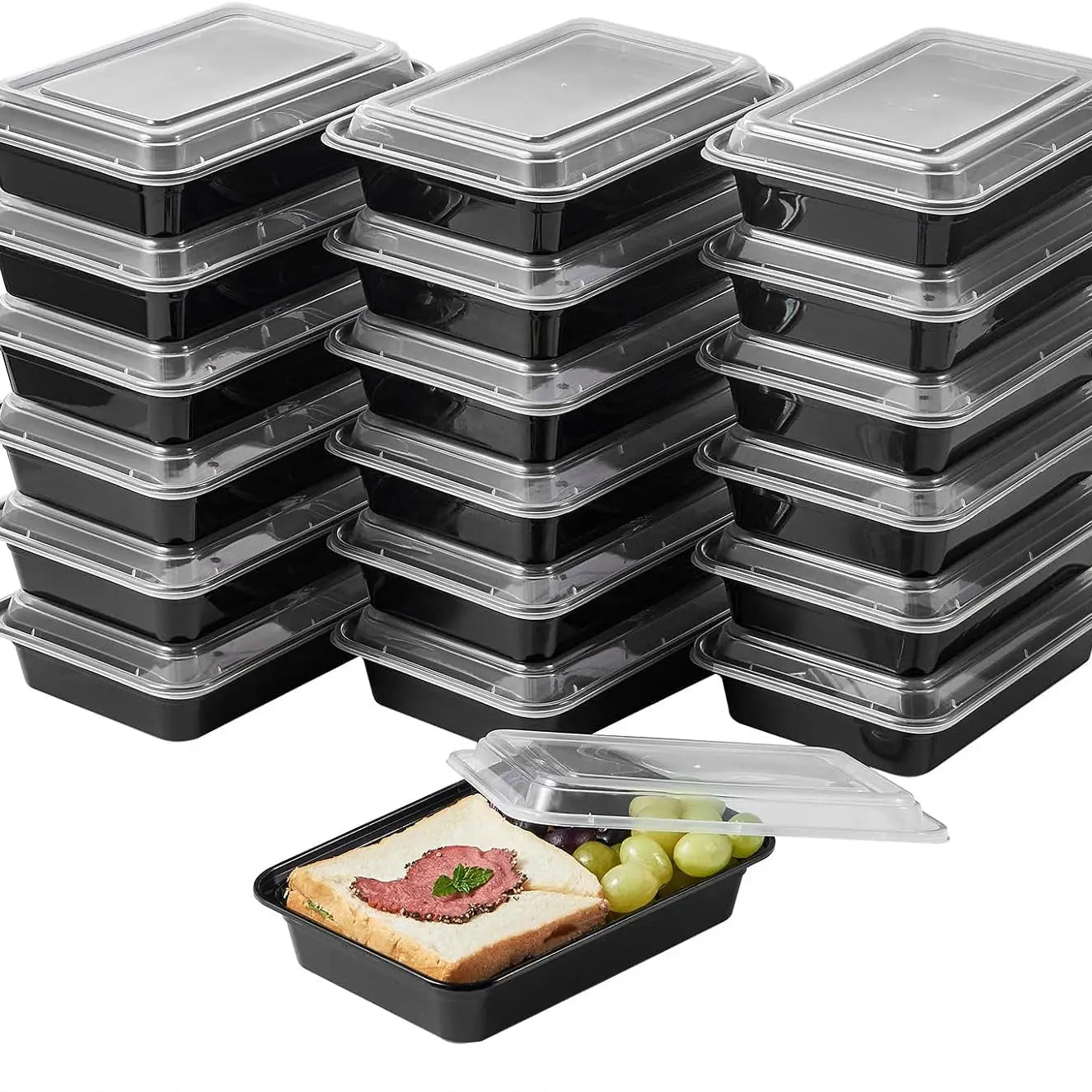 Multiple black meal prep containers with clear lids on a white background.