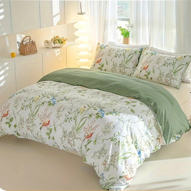 Floral and bird print duvet cover set with soft green reverse on a styled bed