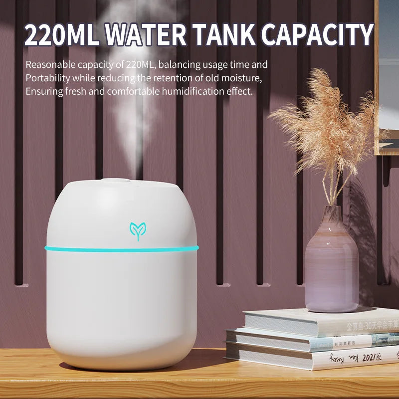 White humidifier with a water tank capacity of 220ml on a wooden surface with a vase and books in the background.