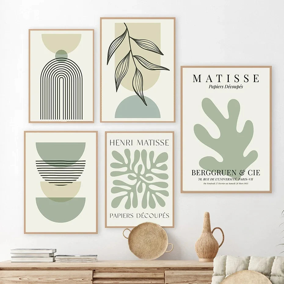 Set of abstract art prints on a wall with a wooden cabinet below.