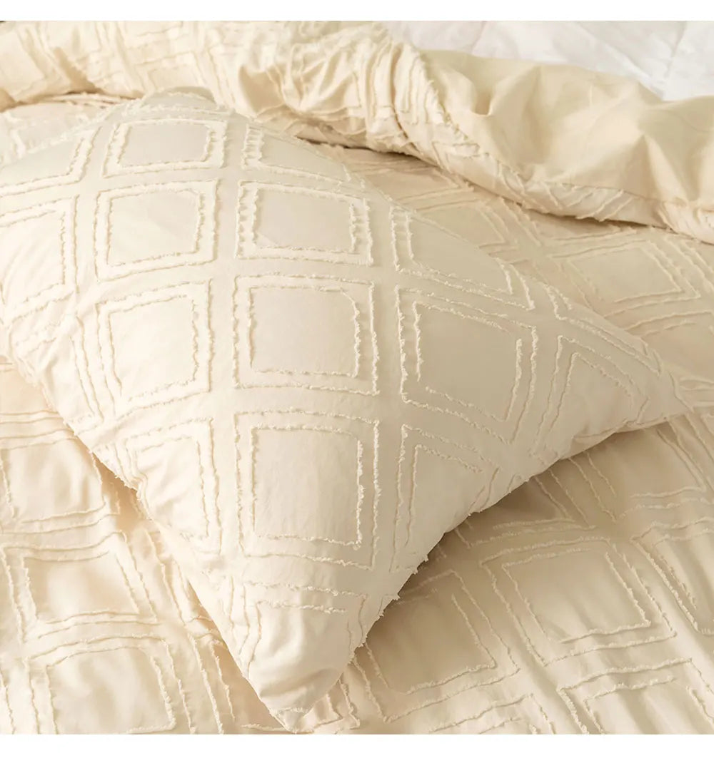 Cream textured geometric bedding set with matching pillowcases styled on a minimalist bed