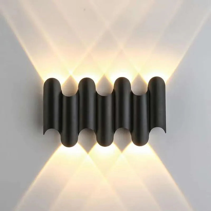 Black 4-wave modern wall light with sculptural silhouette and ambient LED beam effect