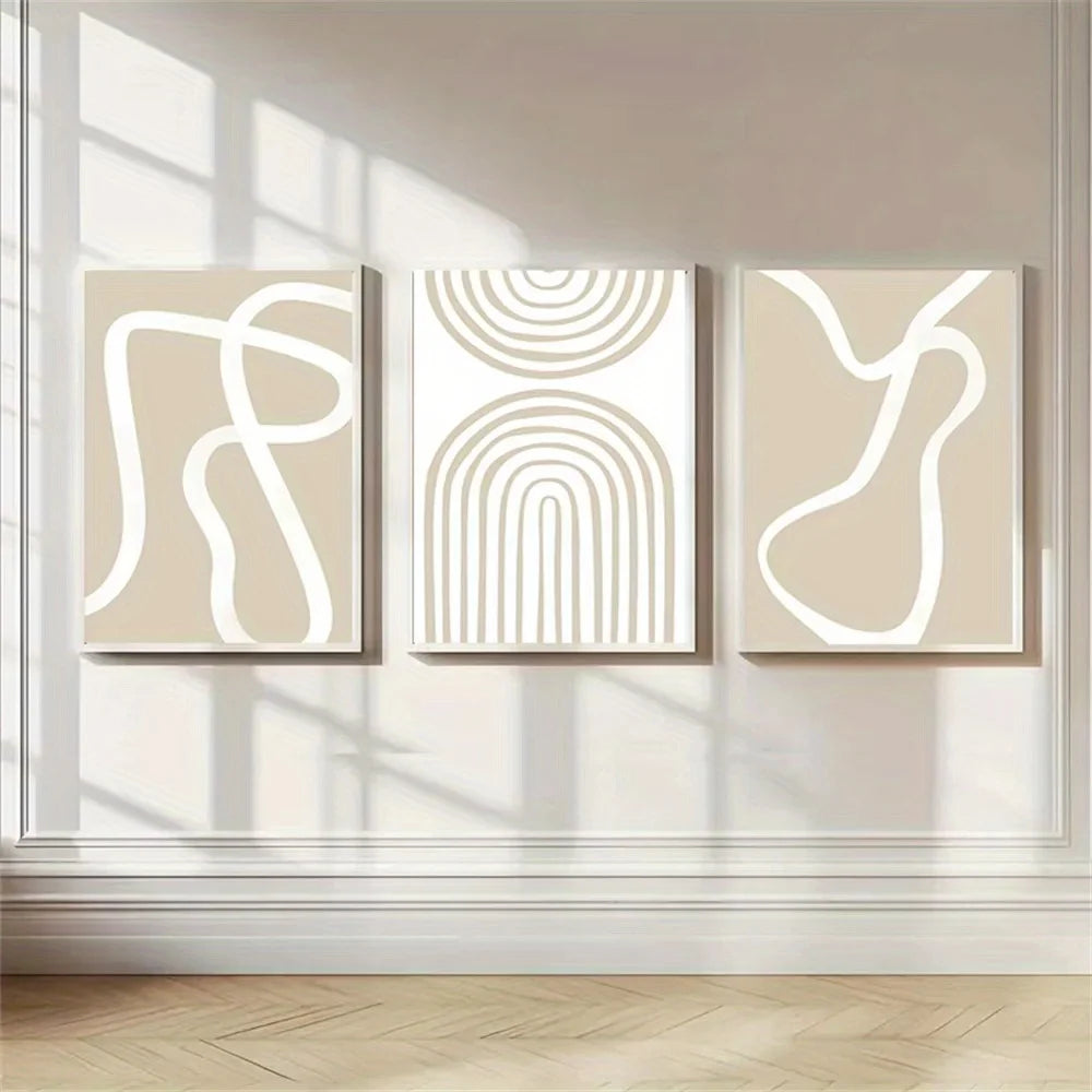 Three abstract line art canvases displayed above a beige sofa in a modern living room.