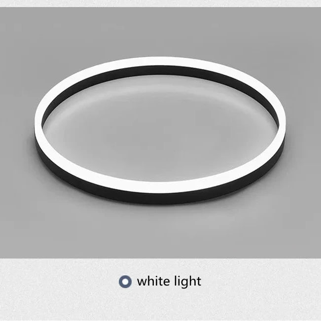 Circular light fixture with white rim on a gray background
