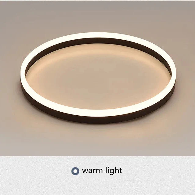 Modern ceiling light fixture with warm light on a neutral background