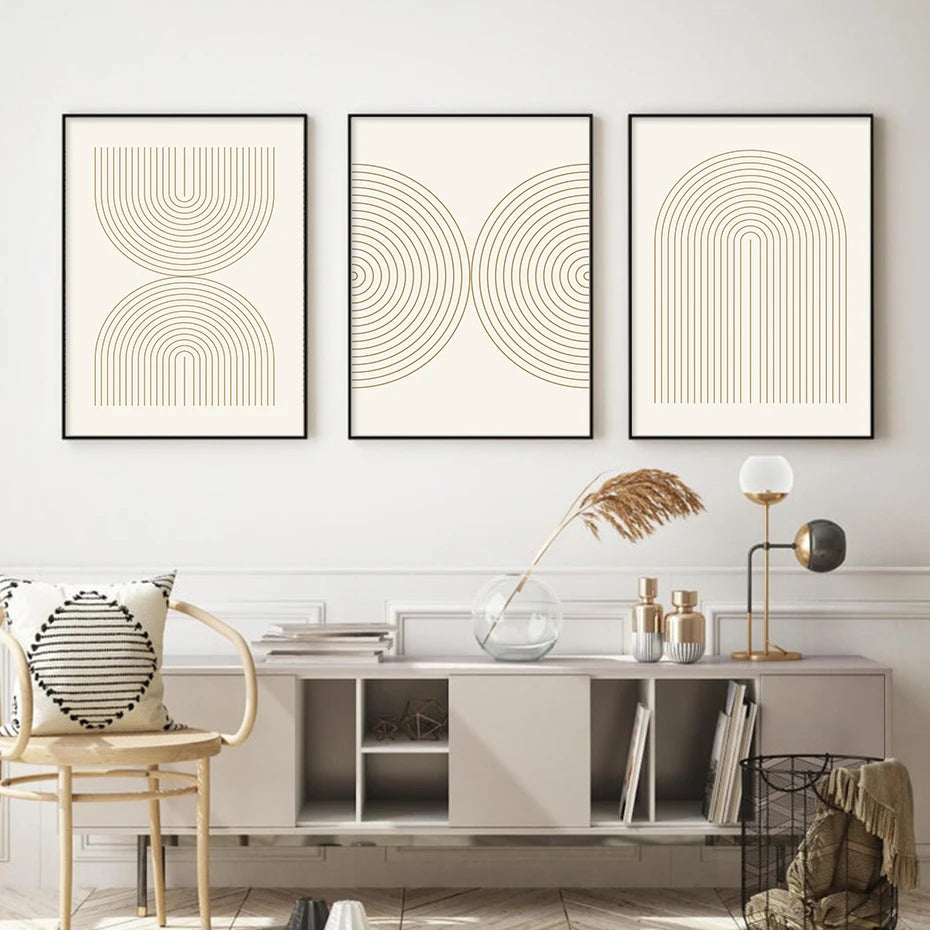 Three abstract art prints on a wall above a modern console table.